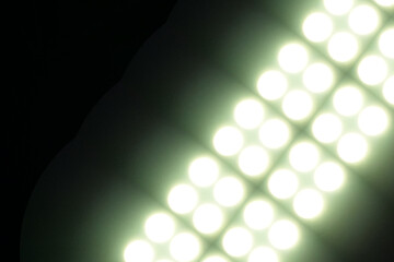 The big lights dazzle the stadium and the black background
