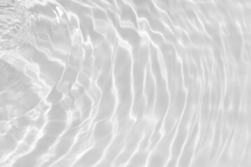 White water with ripples on the surface. Defocus blurred transparent white colored clear calm water surface texture with splashes and bubbles. Water waves with shining pattern texture background.