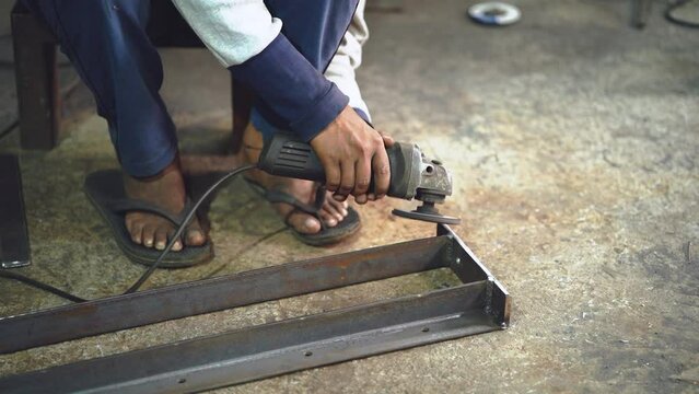 Working with Power Tools - Stock video of Man Using Angle Grinder with Sparks Flying, Man using angle grinder sparks, Worker cutting metal with grinder 