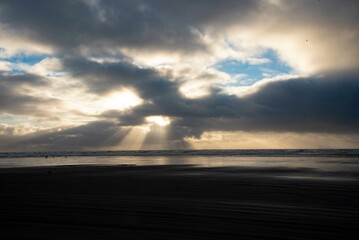 Dramatic Sun Rays through Clouds at Ocean Beach