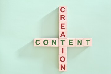 Content creation concept. Crossword puzzle flat lay typography in green background.