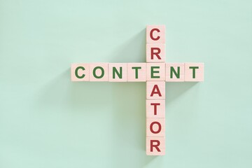Content creator as career concept. Crossword puzzle flat lay typography in green background.