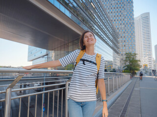 Female tourist traveling in Austria, capital city Vienna. summer female solo trip to Europe, happy young woman walking in Donaustadt district street