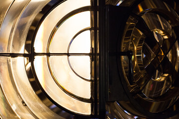 Close up photo of a lighthouse lamp with Fresnel lens mounted on metal frame