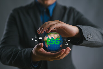 Businessman holding globe with ESG icon green earth concept for environment Society and Governance...