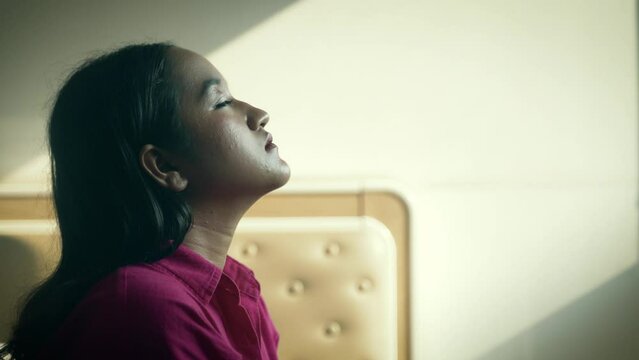 Sad teenage girl taking a deep breath feeling alone depressed