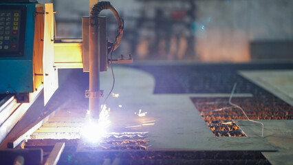 laser cutting machine working with sheet metal with sparks metalworking industrial manufacturing...