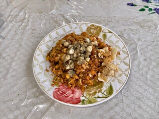 Oh Tao the famous street food of Phuket Thailand. Oh tao is combining boiled taro root, oysters, eggs, flour, garlic, onions, dried chilis, crispy pork rind, bean sprouts, and soy sauce.