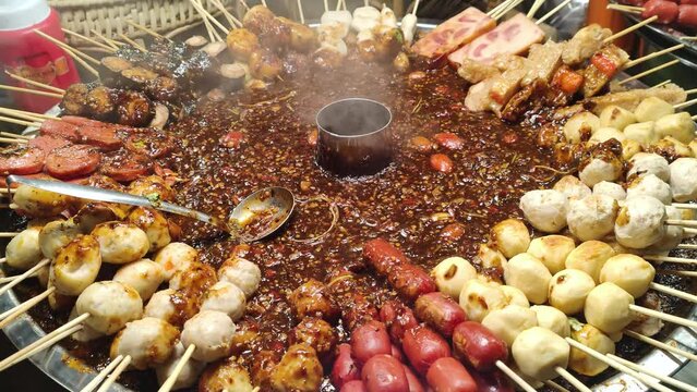 Traditional Thai BBQ Sausages and Fish Ball Satay at Night Marke