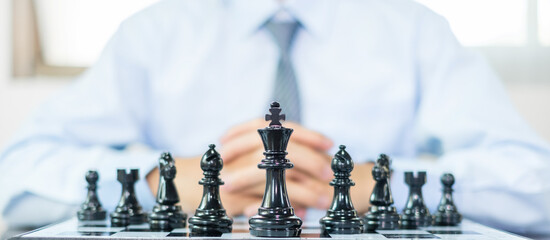 hand of businessmen moving chess in competition shows leadership, followers and business success...