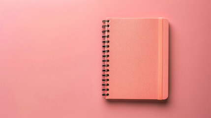 Notebook on pink background, top view, copy space for text