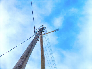 Old pole with wires against the sky. Electric transmission line. Eco-friendly energy