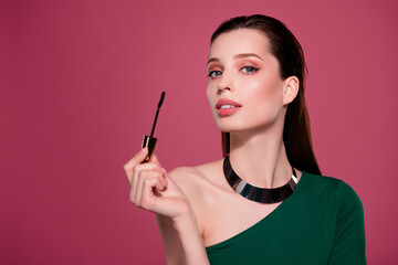 Photo of alluring chic girl with mascara brush doing make up for festive event occasion over pink...