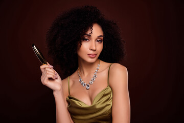 Portrait of attractive woman hold mascara advert dressed trendy silky clothes isolated on brown color background