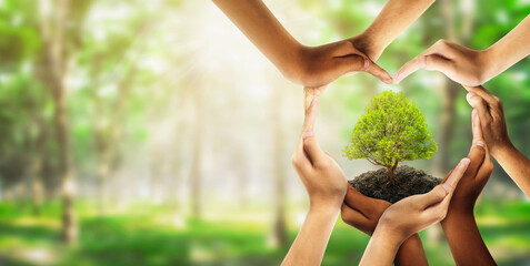 Earth day and earthday as group of diverse people joining to form heart hands connected together protecting the environment and promoting conservation and climate change issues as an image. - obrazy, fototapety, plakaty