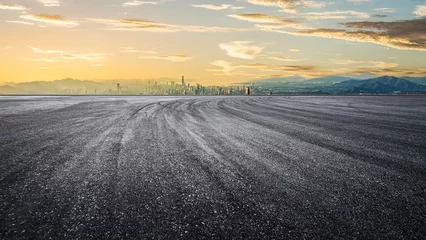 Fotobehang Empty asphalt road and mountains with city skyline background © zhao dongfang