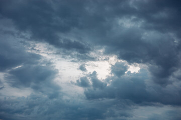 Dramatic Sky Punctuated by Glimpses of Sunlight Through Storm Clouds