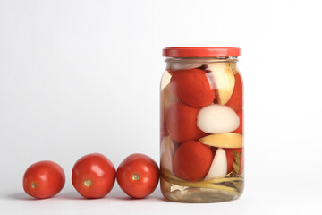 Pickled Canned tomatoes in glass jar on white background