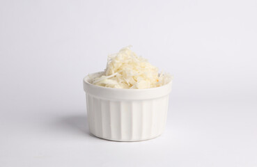 Sauerkraut in a ceramic bowl on white background