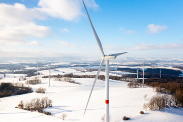 Panoramic view of renewable energy wind turbines in the mountain in winter