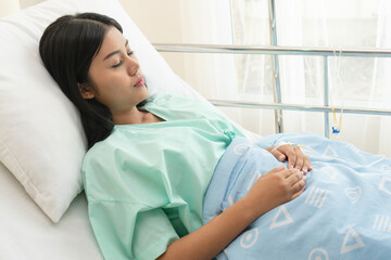 female patient  lying on the bed in hospital