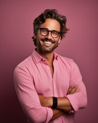 Fototapeta premium Portrait of a smiling man wearing glasses and elegant shirt, pink background on pink background. Optics and eyewear concepts