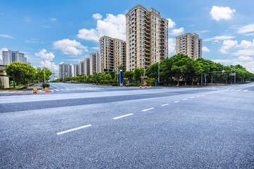 Empty asphalt road and cityscape background