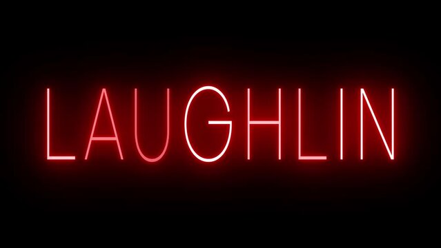 Flickering red retro style neon sign glowing against a black background for LAUGHLIN