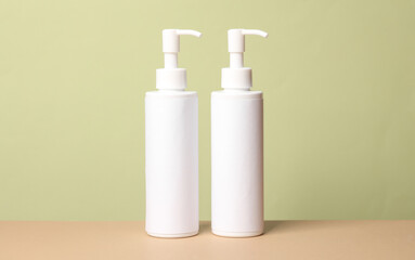 Bottles of cosmetics on a green background