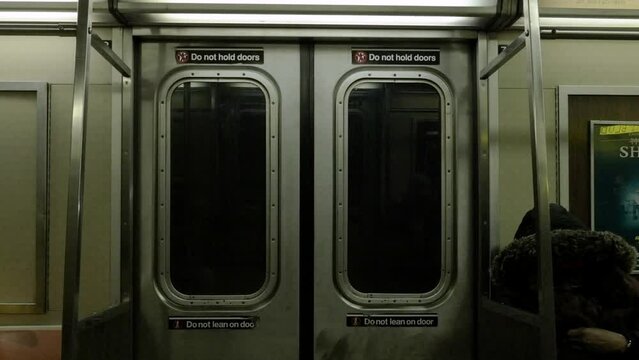 handheld shot of the inside of a subway car