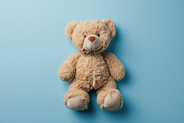 Top view of teddy bear toy on blue background
