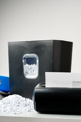Office paper shredder on table against gray background