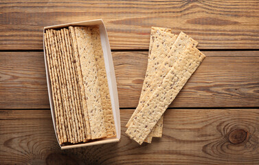Crispy bread on wooden background. Top view