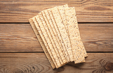 Crispy bread on wooden background. Top view