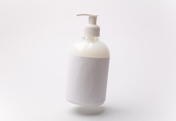 Floating bottle of liquid soap on a white background
