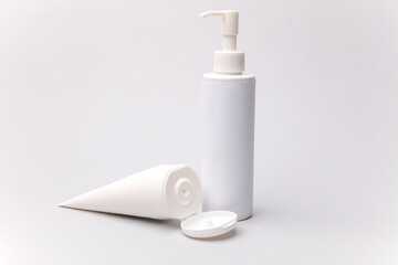White cream bottles on a white background