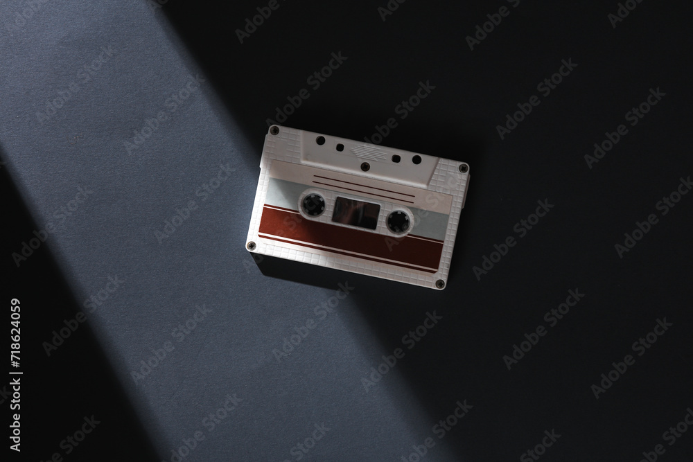 Poster retro audio cassette on a gray background with a stripe of light and shadow. minimalism. concept pho