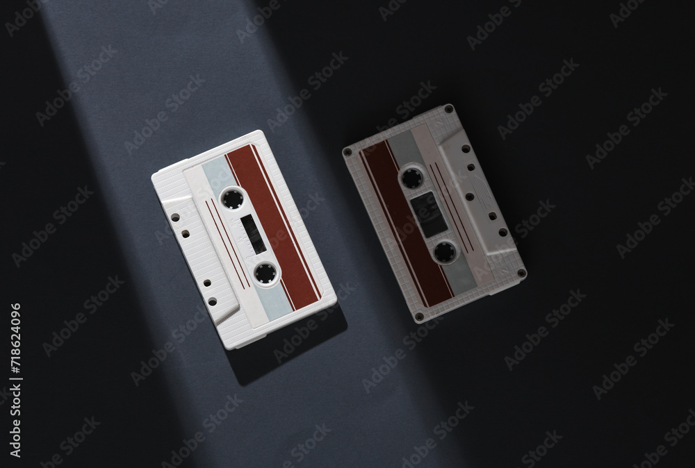Poster retro audio cassettes on a gray background with a stripe of light and shadow. minimalism. concept ph