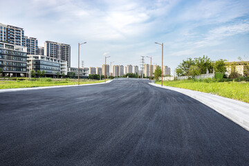 New asphalt road and cityscape background