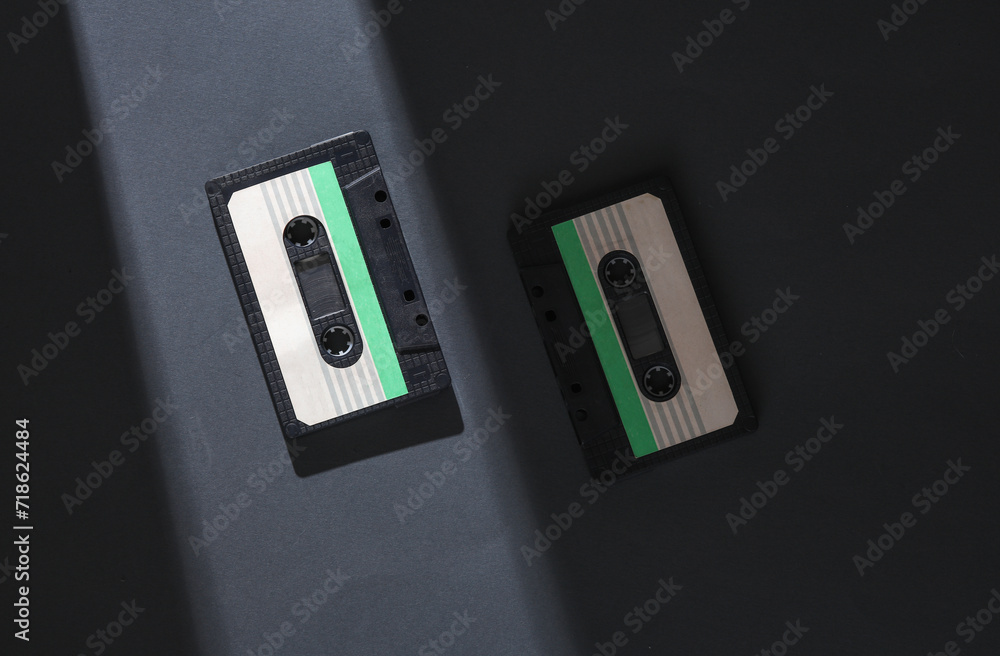 Poster retro audio cassettes on a gray background with a stripe of light and shadow. minimalism. concept ph