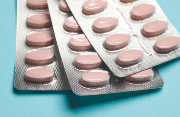 Blisters of fish oil pills on blue background