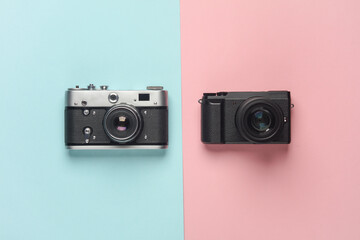 Modern digital and film cameras on a blue pink background