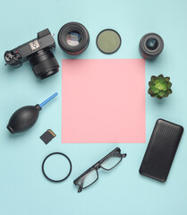 Photographer's equipment and a sheet of paper for information and text on a blue background