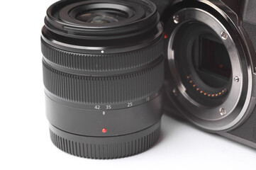 Close up of modern camera with lens on white background