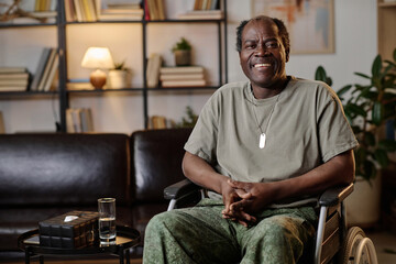 Mature african american war veteran with disability posing at therapist office smiling at camera