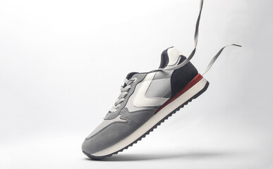 Sport sneakers with flying laces on a white background