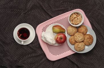 Breakfast in bed. Food on a dark blanket. Top view