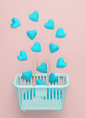 Supermarket basket with hearts on a pink background. Shopping, sale, valentine's day concept