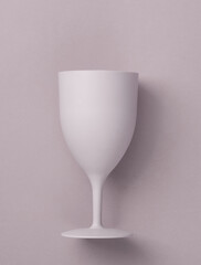 Plastic wine glass on a pastel background
