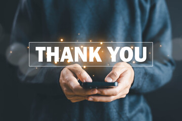 businessman using a smartphone and showing the message thank you on a display screen. concept of thank you business, congratulations, presentation from technology digital, appreciation, and gratitude 